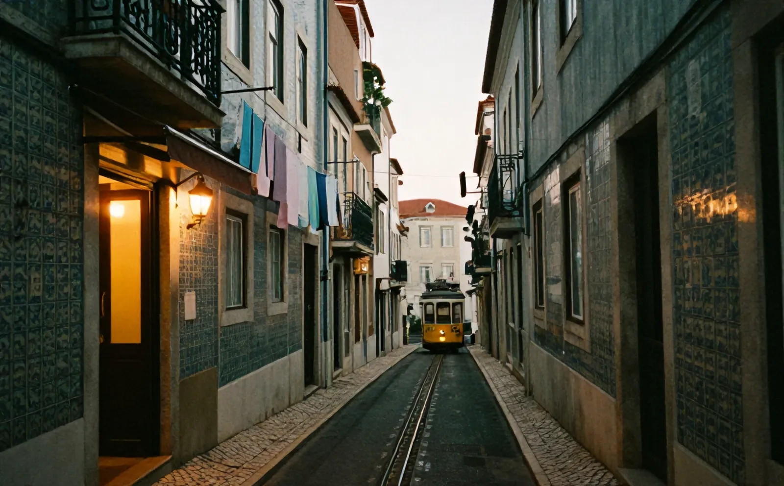 A steep lane in Alfama at dusk near Osteria Nove