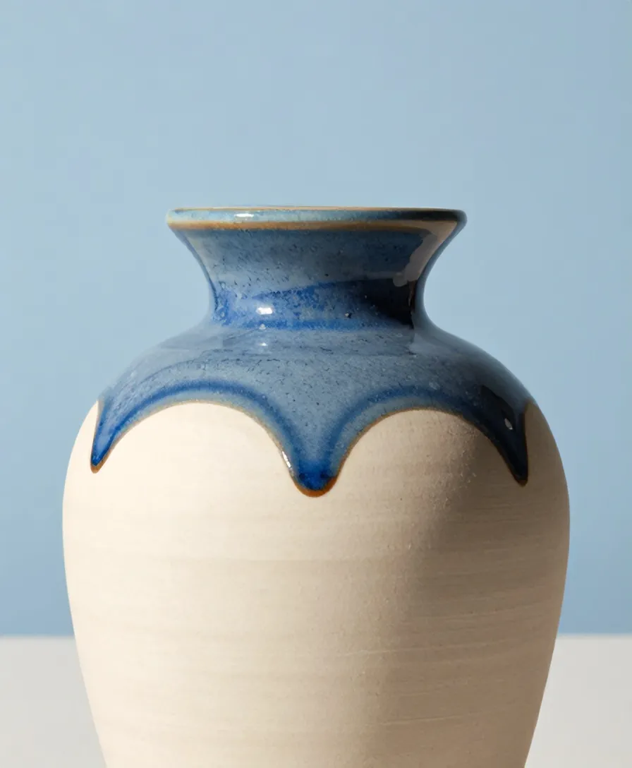 A speckled blue drip frozen halfway down a carafe