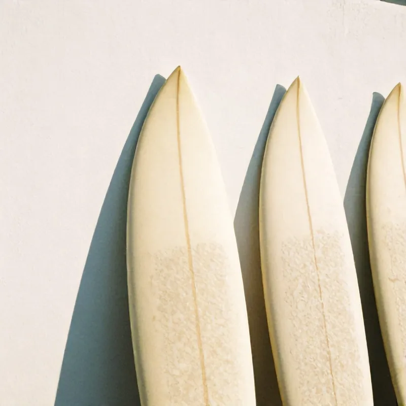 Surfboards resting against a whitewashed wall