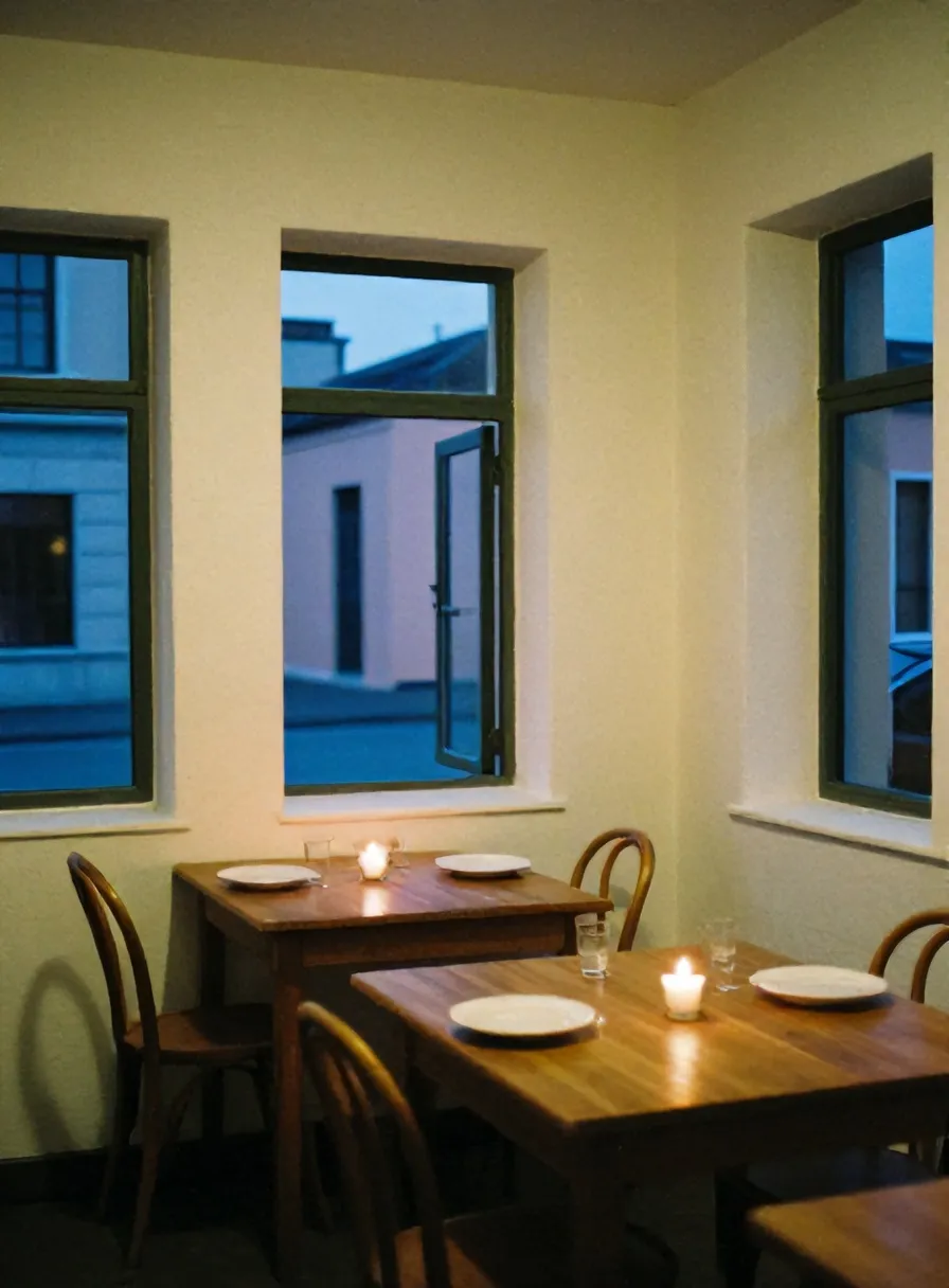 The small whitewashed dining room of Osteria Nove at dusk, candles lit on wooden tables, blue light in the window