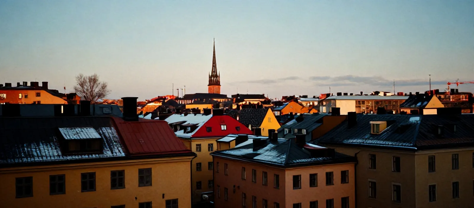 Stockholm rooftops at winter dusk, ochre and red façades, copper roofs with snow