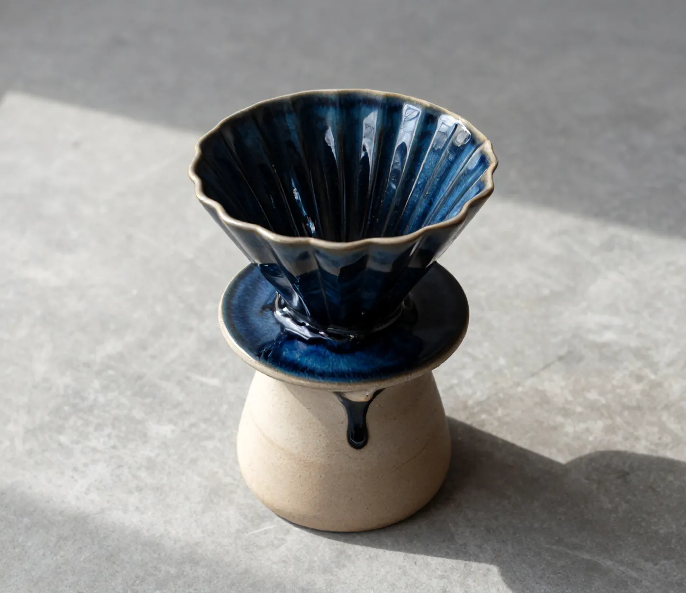 A Kiln dripper and carafe seen from above, glaze pooled around the rim