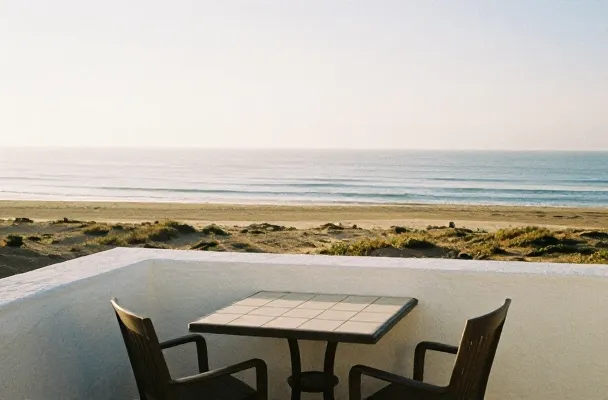 The terrace table set for breakfast above the sea