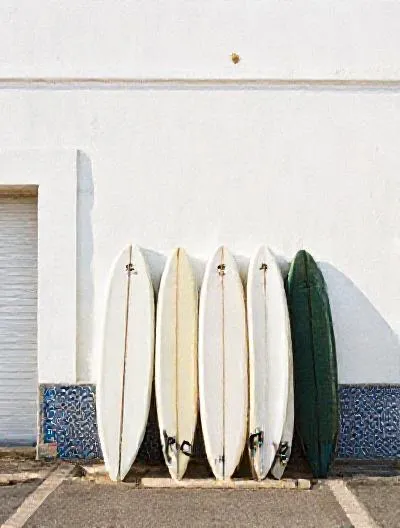 Surfboards leaning on a whitewashed wall