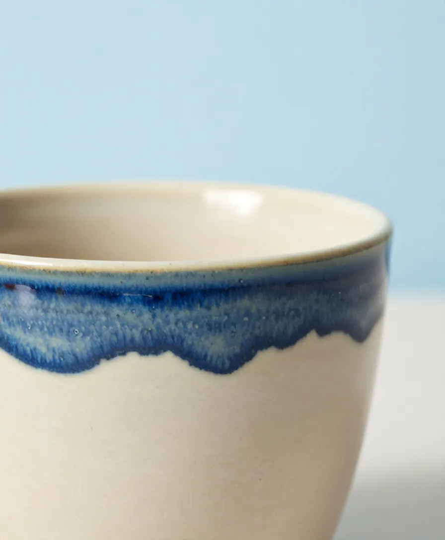 Glaze pooled thick at a cup rim