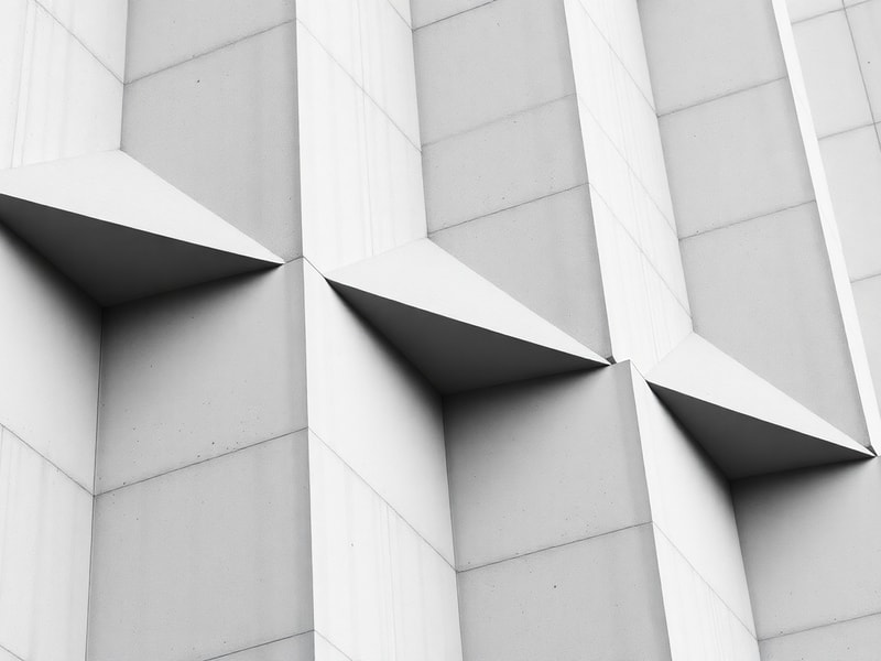 Clean facade detail of repeating concrete panels and sharp angles